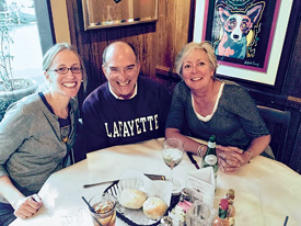 Jennifer Schott ’98 (L–R) and Dennis Vitrella ’73  with Jenny Weisburger ’82 at the Blue Dog Cafe