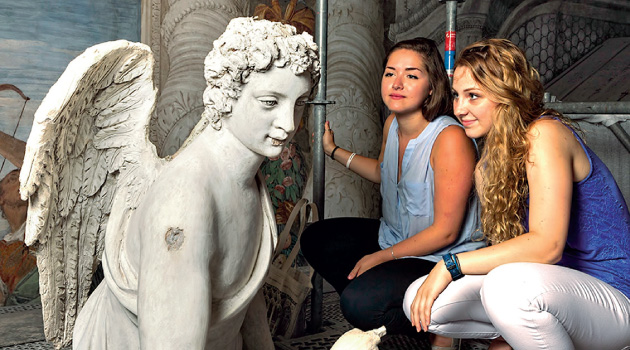 Genna Asselin ’15 (right) and Kayla Metelenis ’15 examine a sculpture of Archangel Gabriel by Girolamo Campagna (1582) in the Monks’ Loft of the church of San Sebastiano.