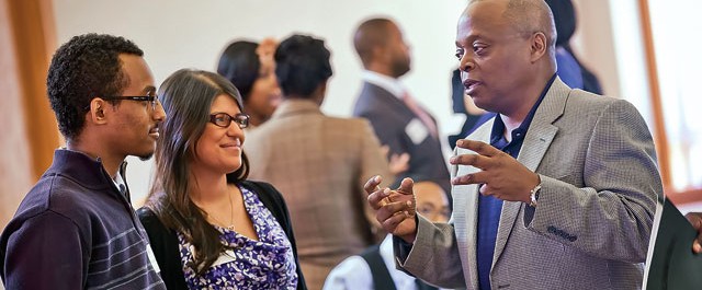 Abenezer Solomon ’14 (left) and Beatriz De Jesus ’12 talk with Judge Alvin Yearwood ’85.