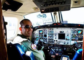 Will Cason '99 in a C-12 Huron, a twin-engine turboprop military passenger and transport aircraft, at North Island Naval Air Station, outside of San Diego.