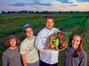 John Soder, executive chef of dining services, holds some of the LaFarm produce used in the College dining halls.