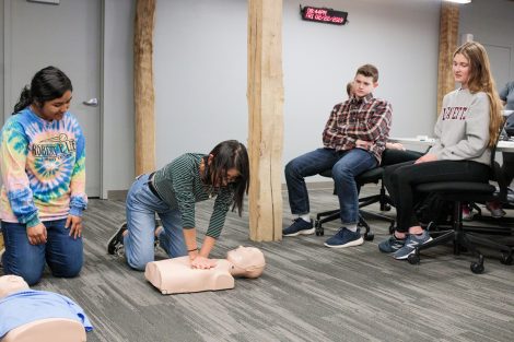 Student emergency medical technicians practice CPR.