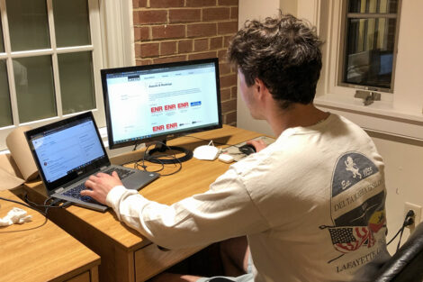 Lafayette engineering student Michael Anderson works on parklet project on two computer screens