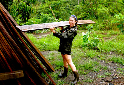 Camille Borland ’13 grabs her last plank. The students made three two-mile roundtrips into the jungle to carry out boards for a building project at the botanical garden site.