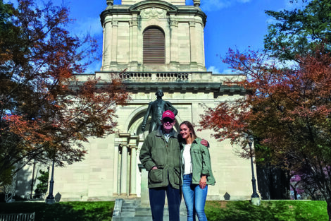 Don Kein ’59 stands with granddaughter in front of the Marquis de Lafayette statue by Colton Chapel